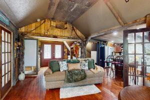 a living room with a couch in a house at Walk to Trails & Fishing Spots! Lake Ozark Escape in Four Seasons