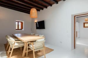 a dining room with a wooden table and chairs at New! Villa Plana Menut in Santa Gertrudis de Fruitera