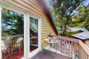 a balcony with a table and a glass door at Walk to Trails & Fishing Spots! Lake Ozark Escape in Four Seasons