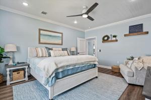 a bedroom with a bed and a ceiling fan at Just Beach It! in Port Bolivar