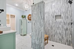 a bathroom with a shower with a glass wall at Just Beach It! in Port Bolivar +47 photos