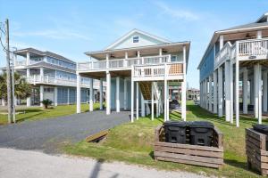 a row of houses on a street with trash at Just Beach It! in Port Bolivar
