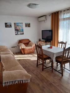 a living room with a table and a couch at Maja Apartman in Igalo