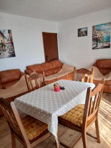 a living room with a table and chairs and a couch at Maja Apartman in Igalo