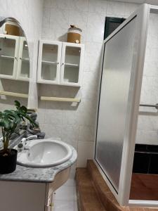 a bathroom with a sink and a shower at Descanso imparcial in Prazeres +3 photos