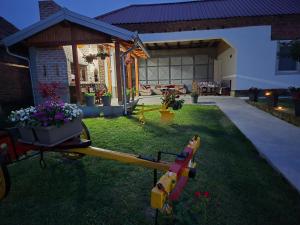 a backyard of a house with a flag and flowers at Studio Villa Ruža in Golubac