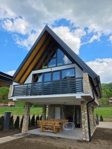 a house with a wrap around porch with a deck at Villa Sanja I Villa Aleksa in Bratunac