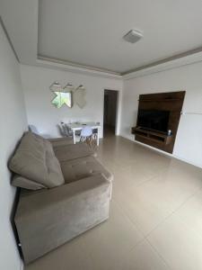a living room with a couch and a table at Aparth ijui hotel in Ijuí