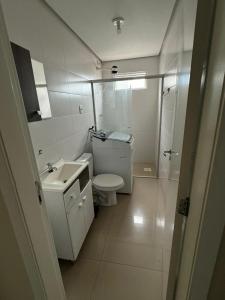 a bathroom with a toilet and a sink and a shower at Aparth ijui hotel in Ijuí