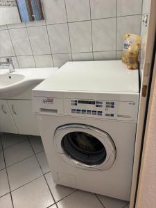 a washing machine in a bathroom with a sink at Bellavista Home 2 in Trimbach
