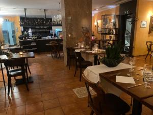 a restaurant with tables and chairs and a bar at Bellavista Home 2 in Trimbach