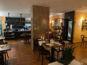 a restaurant with tables and chairs and a bar at Bellavista Home 2 in Trimbach