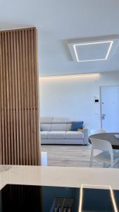 a living room with a couch and a table at Casa Amarèa in Fano