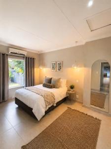 a bedroom with a large bed and a large window at Lenmed Prime Spot in Kimberley