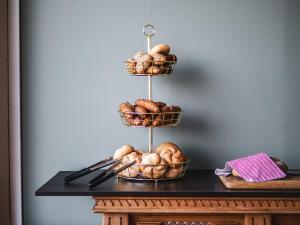 a stand with baskets of bread on a table at Faaker See Inn by Aurora in Faak am See