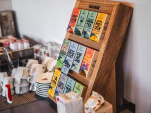 a shelf with books on it next to a counter at Faaker See Inn by Aurora in Faak am See +38 photos