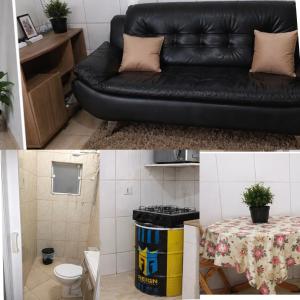a living room with a black couch and a table at Espaço Recanto dos Sonhos DR in Itaquaquecetuba +5 photos