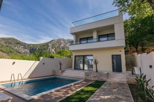 a villa with a swimming pool and a house at Villa MIO in Bar