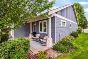 a small gray house with a patio in the yard at Schweitzer & Dover Bay - Ski Lake Dine in Dover