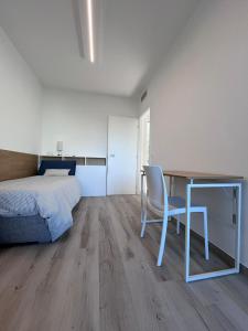a bedroom with a bed and a desk with a chair at Casa Amarèa in Fano +6 photos
