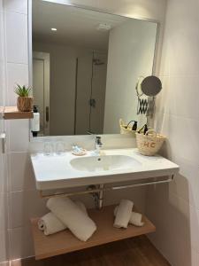 a bathroom with a sink and a mirror at Carabela in Paguera +51 photos