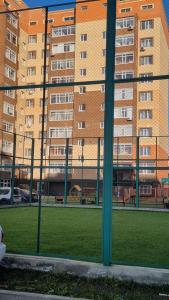 a view of a large building from a window at Luxury in Kokshetau