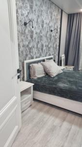 a bedroom with a bed and a wall with flowers at Luxury in Kokshetau