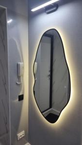 a bathroom with a round mirror on the wall at Luxury in Kokshetau +25 photos
