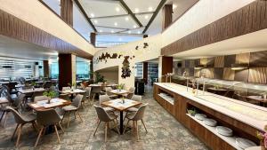 a restaurant with tables and chairs and a bar at BSA Gradina Hotel & Aquapark - All Inclusive in Golden Sands