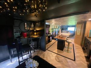 a kitchen and living room with a table in a room at Simons Whody Hideaway in Ulcombe