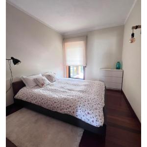 a bedroom with a bed and a window at Casa SAL in Esposende