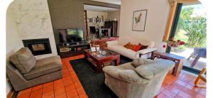 a living room with two chairs and a television at Casa SAL in Esposende