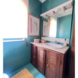 a bathroom with a sink and a mirror at Casa SAL in Esposende +16 photos