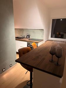 a kitchen with a wooden table with chairs in it at LevelUp Comfort in Koblenz +10 photos