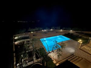 an overhead view of a swimming pool at night at Villa Maginja in Sutivan +55 photos