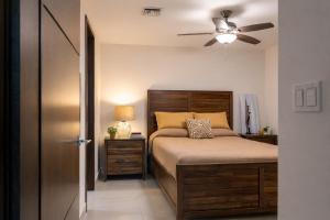 a bedroom with a bed and a ceiling fan at Panoramic Oceanfront Resort Style Condo in Rosarito +21 photos