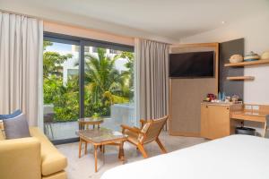a hotel room with a bed and a large window at Haven Riviera Cancun - All Inclusive - Adults Only in Cancún