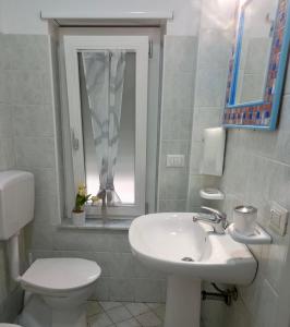 a bathroom with a sink and a toilet and a window at Umberto I in Nicosia