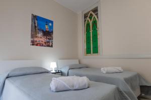 a room with two beds and a window at Umberto I in Nicosia