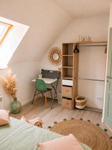 a bedroom with a bed and a desk and a table at Côte d'Opale - Maison Cocooning Classé 3 Étoiles in Marquise
