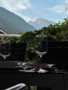 a table with two wine glasses on top of it at Sončna vila Bovec, Studio A&B in Bovec