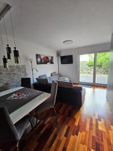 a living room with a table and a couch at Sončna vila Bovec, Studio A&B in Bovec