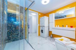 a bathroom with a shower and a washer and dryer at Yellow View Apartment - Ronco S Ascona - Happy Rentals in Ronco sopra Ascona +14 photos