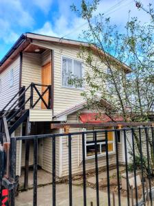 a house with a staircase in front of it at Casa kumey in Puerto Varas