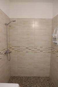 a shower with a glass door in a bathroom at Villa Adriano in Salve +19 photos