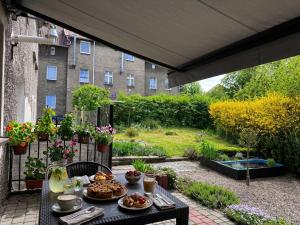 a table with food on it on a patio at Apartament pod Osówką in Głuszyca