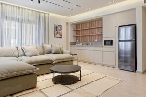 a living room with a couch and a table at VESTA - Maison Zayed City in Sheikh Zayed