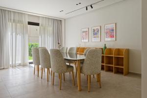 a dining room with a table and chairs at VESTA - Maison Zayed City in Sheikh Zayed +7 photos