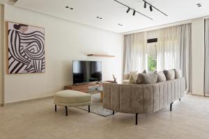 a living room with a couch and a chair at VESTA - Maison Zayed City in Sheikh Zayed