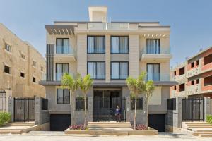 a man standing in front of a building at VESTA - Maison Zayed City in Sheikh Zayed